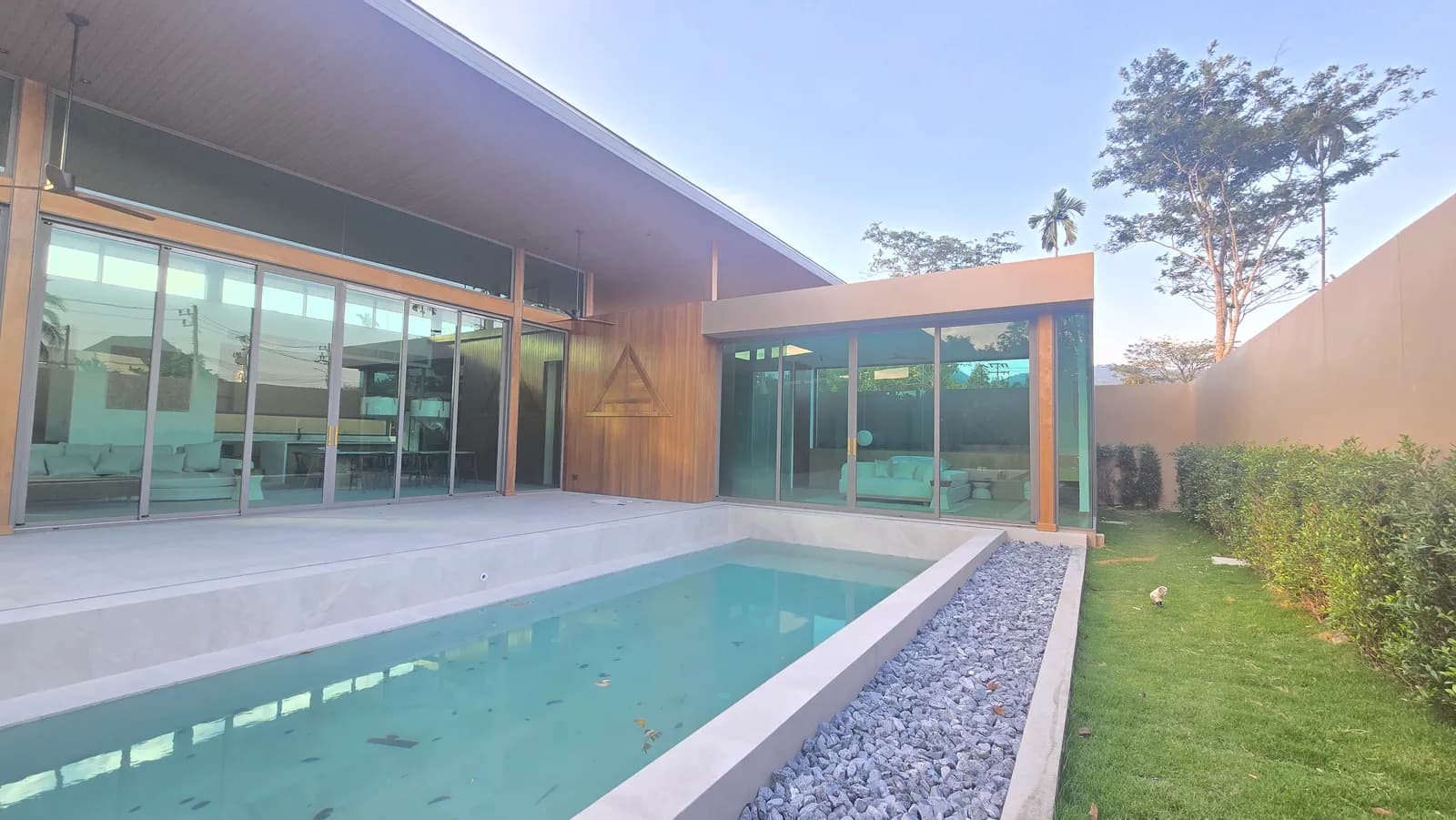 13. Januar 2025: Villa A1 fertiggestellt, Glasfassade, Holzdachüberstand und gefüllter Pool